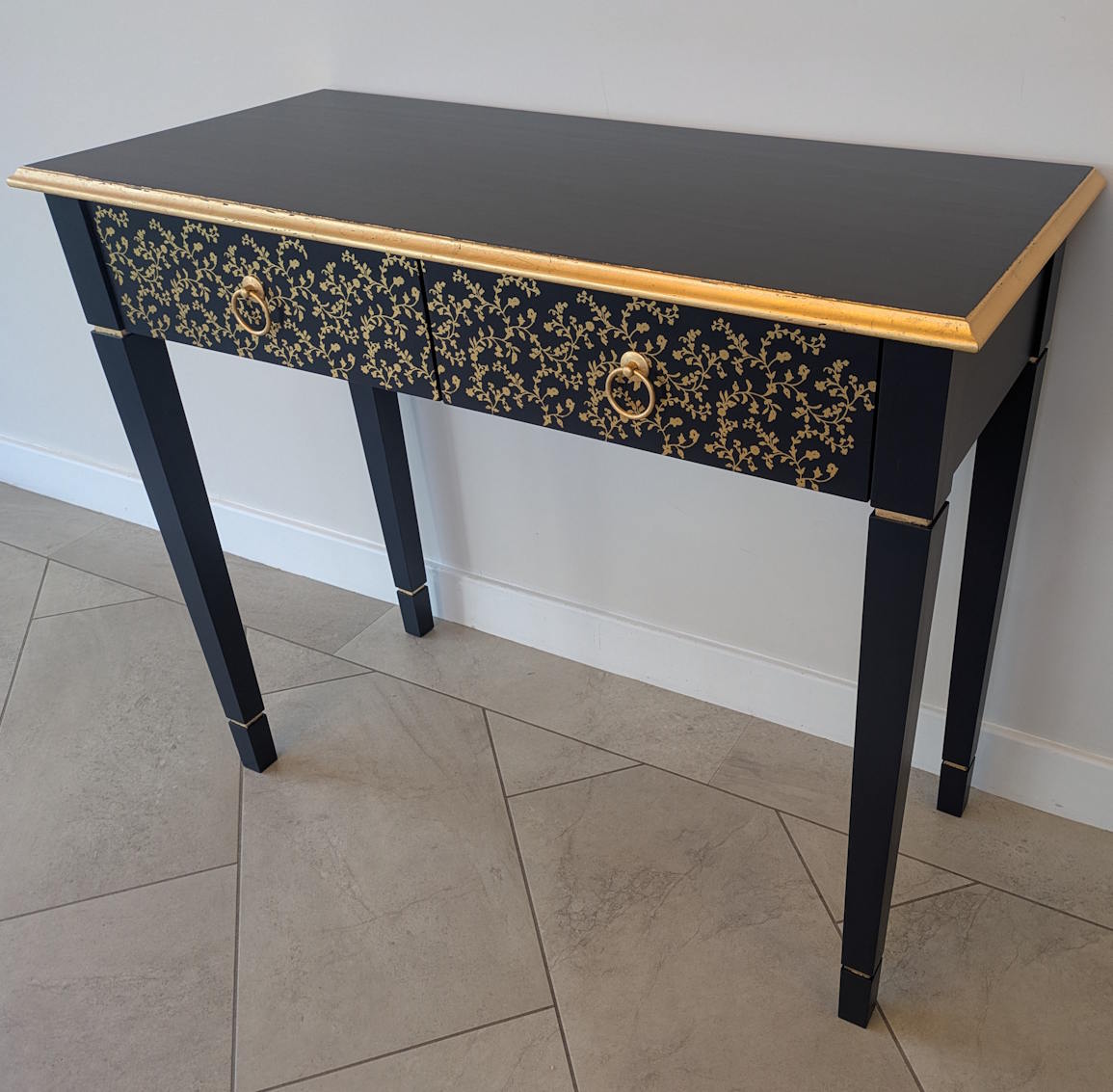 Dark blue console table with gold detailing
