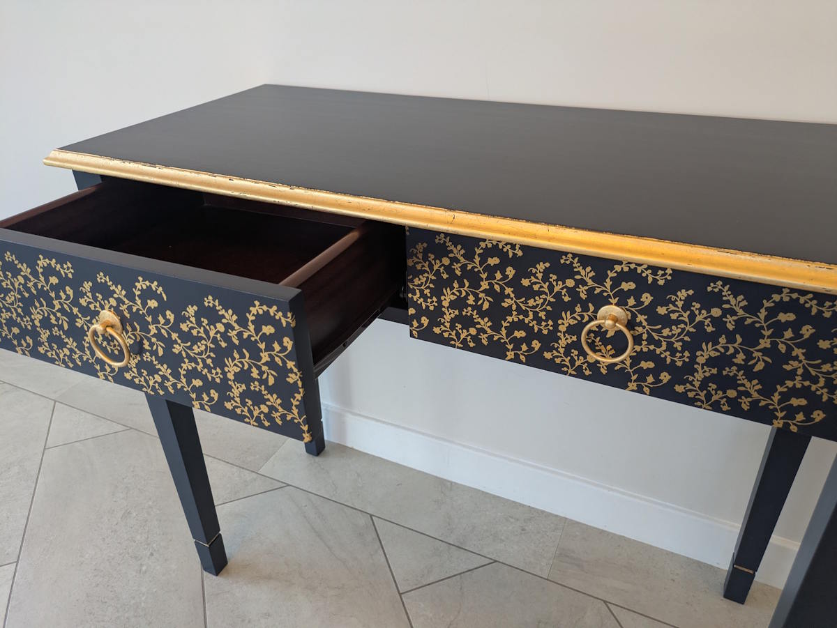 Dark blue console table with gold detailing